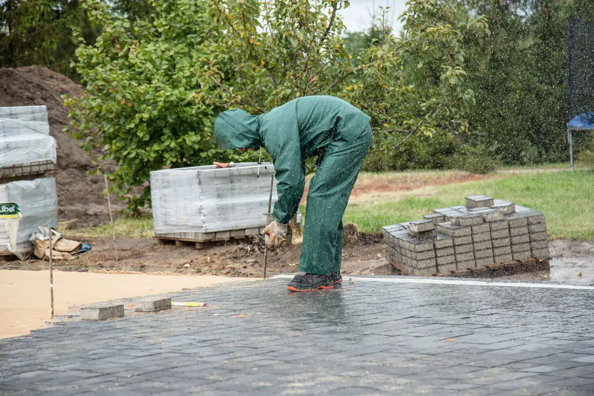 Paver installer setting units on a prepared bed