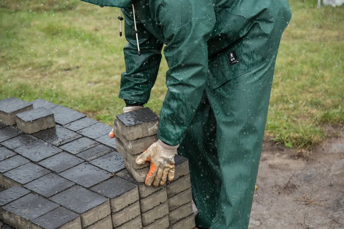 Pavers being handled on site in wet weather
